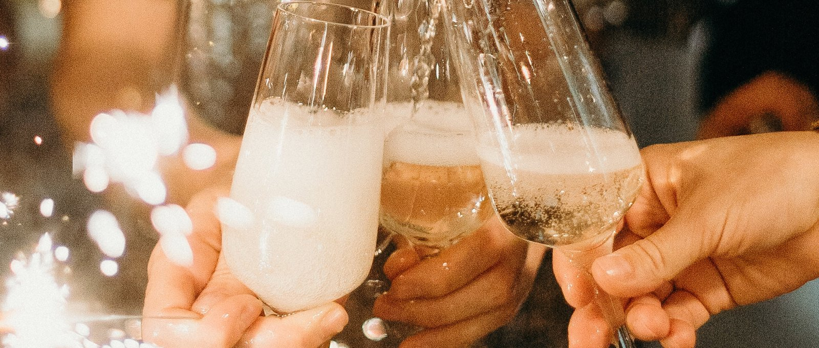 Champagne glasses being filled at a celebration