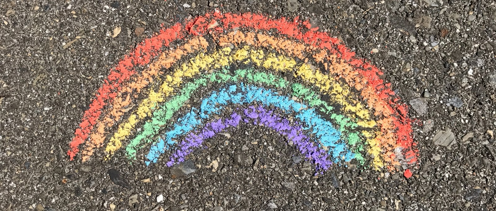A chalk rainbow on a pavement.