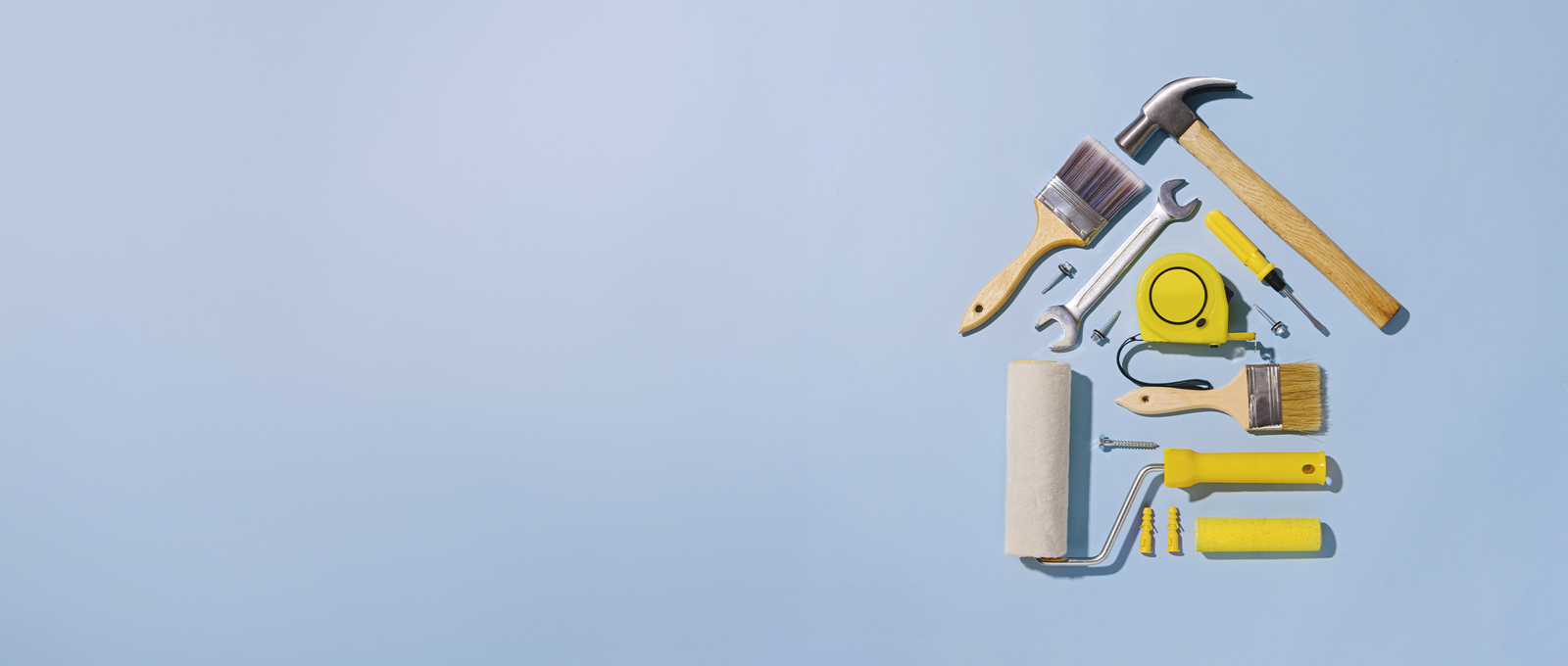 Assortment of DIY tools arranged into a 2D shape of a house