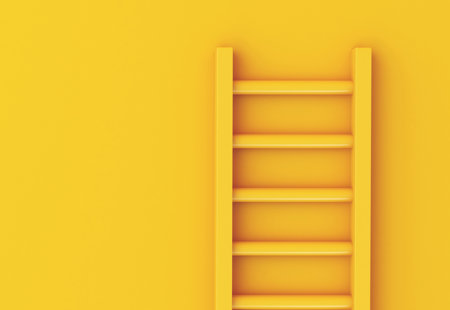 Photo of a yellow ladder leaning against a yellow wall