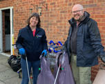 Photo of two of the clean-up day team with their rubbish collection kit