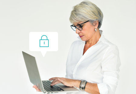 Photo of a woman holding a laptop. An icon of a padlock is floating above the keyboard